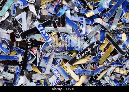 Bank credit cards and debit cards that have been security shredded Stock Photo