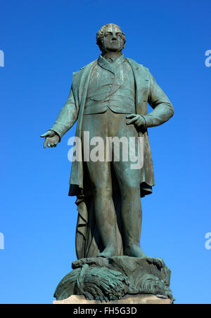 Bronze statue of Sir Robert Peel with verdigris patination and cloudless blue sky in bury lancashire uk Stock Photo