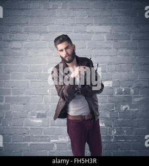 Fashion model in front of brick urban wall Stock Photo