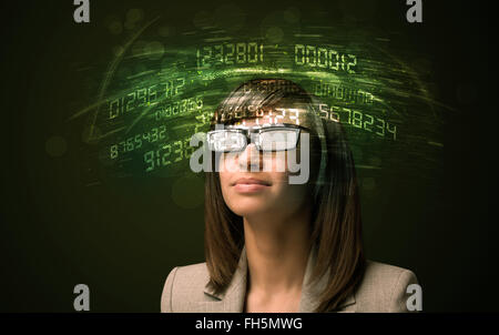 Business woman looking at high tech number calculations Stock Photo