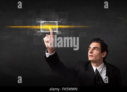 Tech business person touching button with orange light beams concept Stock Photo