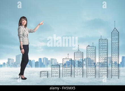 Business woman climbing up on hand drawn buildings in city Stock Photo