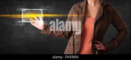Young tech lady touching button with orange light beams concept Stock Photo