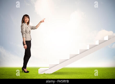 Business person climbing up on white staircase in nature Stock Photo