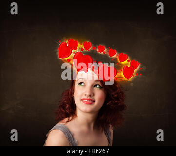 teenager girl with heart illustrations circleing around her head Stock Photo