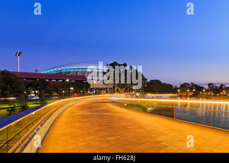 width of modern footbridge over Torrens river in Adelaide, South Australia. Bright illumination lights reflecting in calm waters Stock Photo