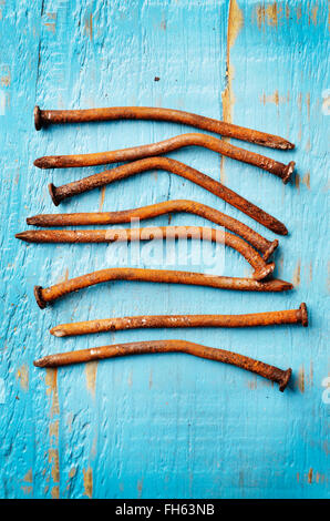 Close-up of Rusty Nails on Painted Wood Stock Photo