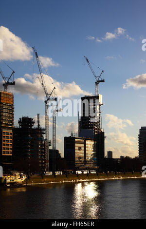 Construction sites and cranes on Albert Embankment next to River Thames, seen from Lambeth Bridge, London, England UK Stock Photo