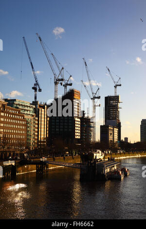 Construction sites and tower cranes on Albert Embankment next to River Thames, seen from Lambeth Bridge, London, England UK Stock Photo
