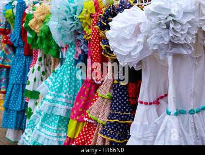gypsy dresses hanging in a row in an andalusian Spain outdoor market Stock Photo