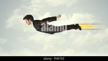 Happy business man flying fast on the sky between clouds Stock Photo