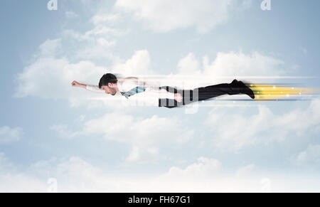 Happy business man flying fast on the sky between clouds Stock Photo