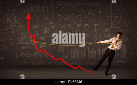 Businessman pulling a red arrow upright with a rope Stock Photo - Alamy