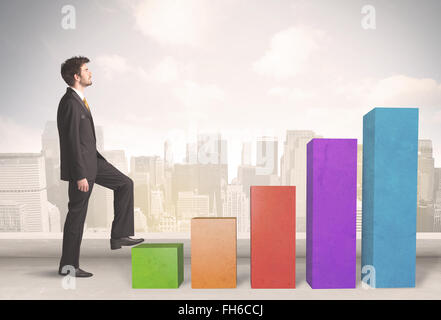 Business person climbing up on colourful chart pillars concept Stock Photo