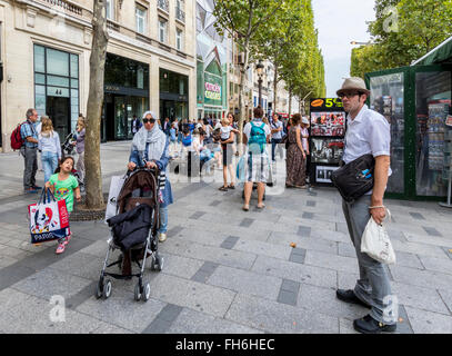 People shopping walking and resting on the famous Champ-Elysees Paris France Stock Photo
