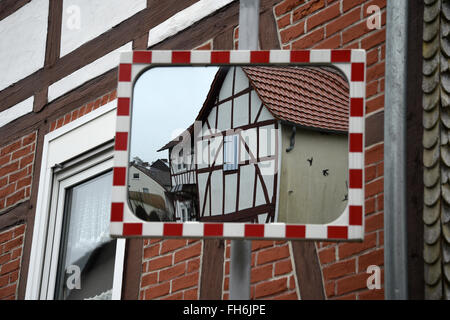 Ottrau, Germany. 10th Feb, 2016. A timber-framed house reflceted in a traffic mirror in Ottrau, Germany, 10 February 2016. PHOTO: UWE ZUCCHI/DPA/Alamy Live News Stock Photo