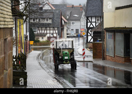 Ottrau, Germany. 10th Feb, 2016. A tractor on the high street in Ottrau, Germany, 10 February 2016. PHOTO: UWE ZUCCHI/DPA/Alamy Live News Stock Photo