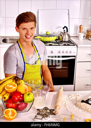 Man baking cookies in oven Stock Photo