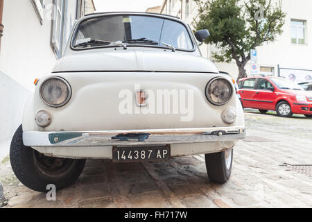 Fermo, Italy - February 11, 2016: Old white fiat 500 L city car on the street of Italian town, close-up front view Stock Photo