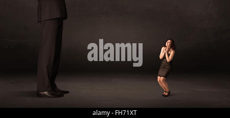 Huge man with small businesswoman standing at front concept Stock Photo