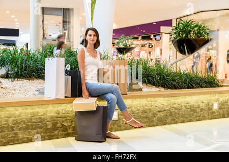 Happy Young Woman Holding Shopping Bags Stock Photo
