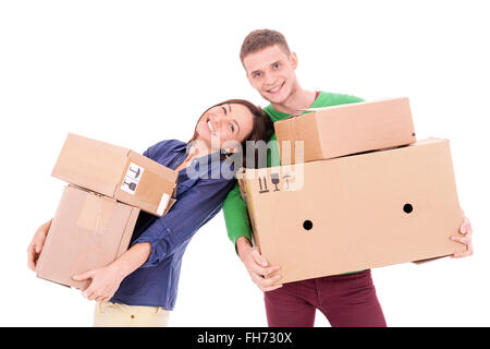 A young casually dressed couple holding cardboard boxes. Possibly moving to a new apartment or house together. Stock Photo