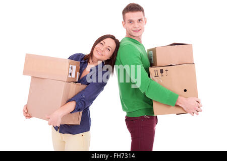 A young casually dressed couple holding cardboard boxes. Possibly moving to a new apartment or house together. Stock Photo