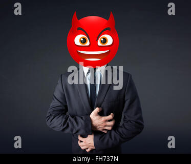 businessman wears devil smiley face Stock Photo