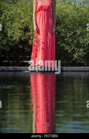 Woman in a red dress in the pool Stock Photo - Alamy