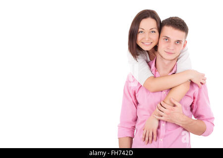 A young heterosexual couple, possibly just married, a wife and a husband standing together, hugging and holding hands. Stock Photo