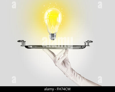 Clever idea concept with bulb on tray Stock Photo