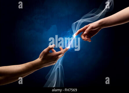 Hands connecting through fingers in space Stock Photo