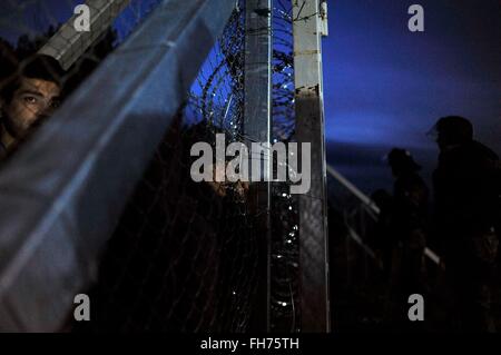 Skopje. 24th Feb, 2016. Afghan migrants protest and stand behind the wire fencing at the closed Greek-Macedonian border, near the Macedonian city of Gevgelija on Feb. 23, 2016. Macedonia has confirmed that it only allowed Syrian and Iraqi refugees through, matching a decision by its northern neighbor, Serbia. Around 5,000 migrants were waiting at the border wishing to continue their journey across Macedonia, Serbia, Croatia, Slovenia and then Austria, with Germany the final goal for most. © Xinhua/Alamy Live News Stock Photo