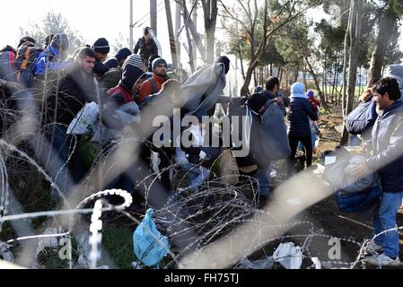 Skopje. 24th Feb, 2016. Afghan migrants protest and stand behind the wire fencing at the closed Greek-Macedonian border, near the Macedonian city of Gevgelija on Feb. 23, 2016. Macedonia has confirmed that it only allowed Syrian and Iraqi refugees through, matching a decision by its northern neighbor, Serbia. Around 5,000 migrants were waiting at the border wishing to continue their journey across Macedonia, Serbia, Croatia, Slovenia and then Austria, with Germany the final goal for most. © Xinhua/Alamy Live News Stock Photo