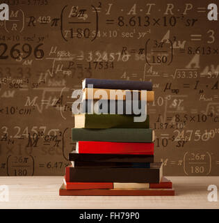 Books on vintage background with math formulas Stock Photo