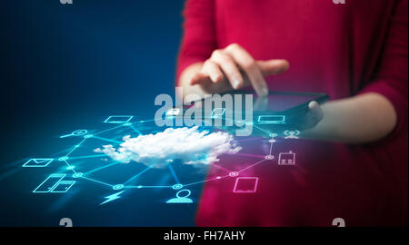 Close up of hand holding tablet with cloud network technology Stock Photo