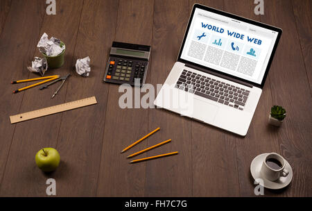 Laptop on wooden desk with office suplies Stock Photo