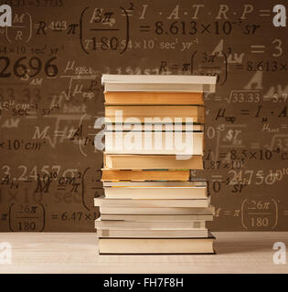 Books on vintage background with math formulas Stock Photo