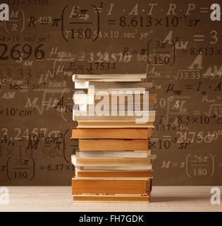 Books on vintage background with math formulas Stock Photo