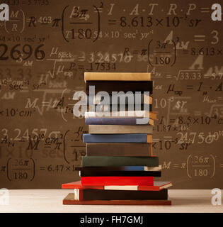 Books on vintage background with math formulas Stock Photo