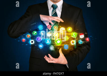 Businessman holding app icon cloud Stock Photo