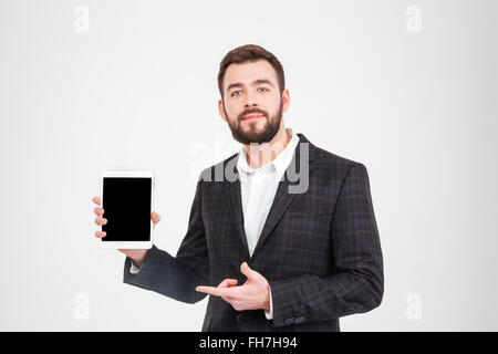 Handsome businessman showing blank tablet computer screen isolated on a white background Stock Photo