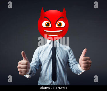 businessman wears devil smiley face Stock Photo