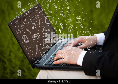 Laptop computer wtih hand drawn icons and symbols Stock Photo