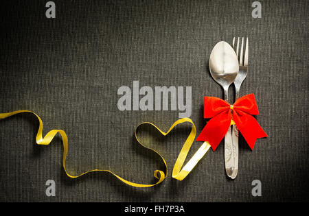 Fork and spoon with ribbon and heart shape Stock Photo