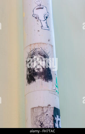 street art stickers, one showing jesus christ wearing a crown of thorns Stock Photo