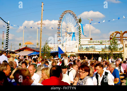 People enjoying nice weather in beer garten at the Oktoberfest in Munich Stock Photo