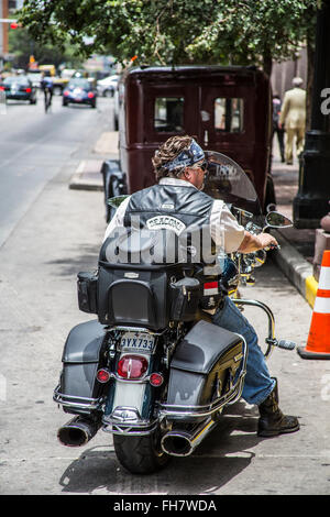 A biker sits on 6th Street in Austin during the ROT Rally Stock Photo