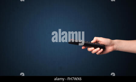 Hand with remote control Stock Photo