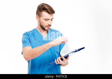 Male doctor reading checklist from clipboard isolated on a white background Stock Photo